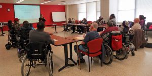 Participants in our program for people with traumatic spinal cord injuries attend a session to prepare them to play active roles in SCI research.